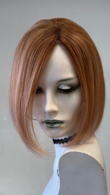 A mannequin with long hair and a black collar.