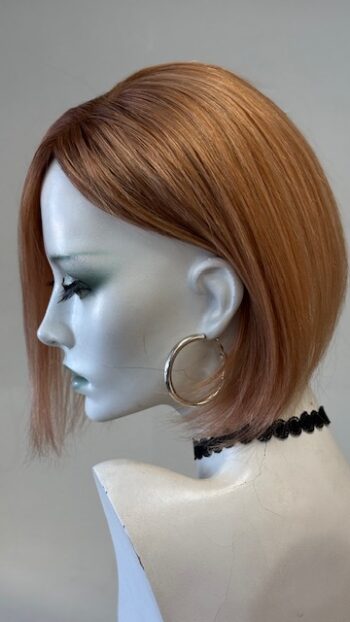 A mannequin with short hair and hoop earrings.