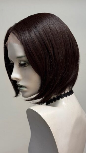 A mannequin head with a black choker and dark hair.