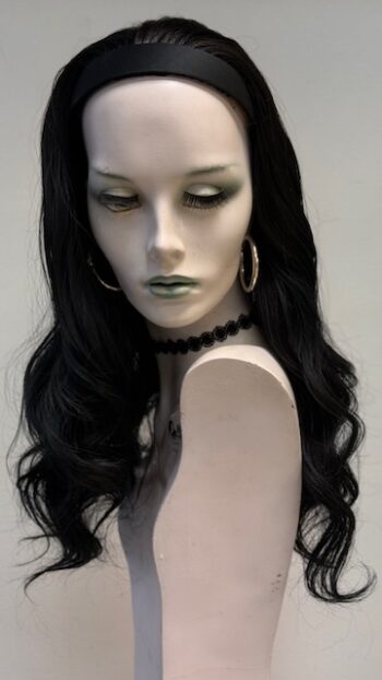 A mannequin with long black hair and green eyes.