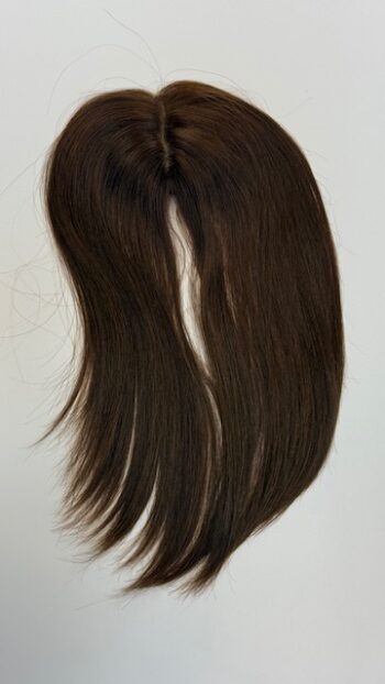 A close up of the back end of a long brown hair wig