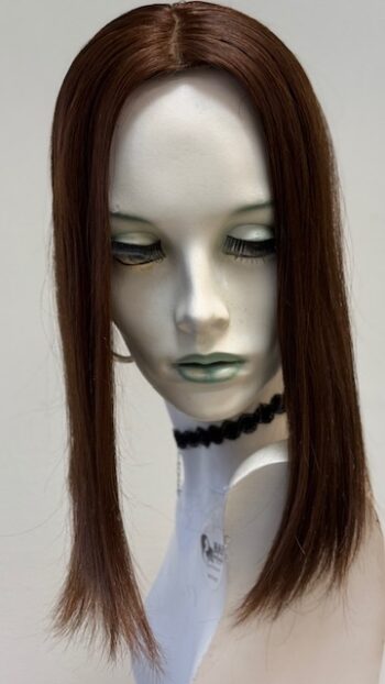 A mannequin with long brown hair and green eyes.