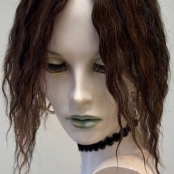 A mannequin head with long hair and green eyes.