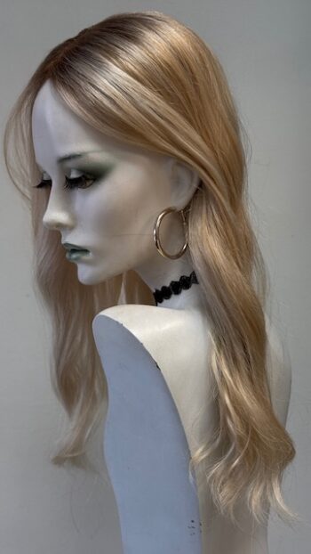 A mannequin with long blonde hair and black beads.