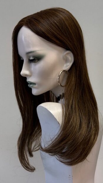 A mannequin with long brown hair and green eyes.