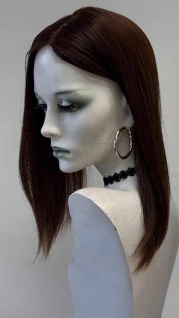 A mannequin with long dark hair and black jewelry.