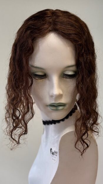 A mannequin head with long hair and green eyes.