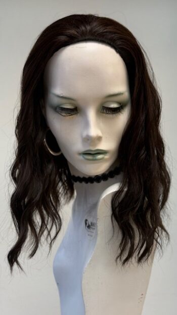 A mannequin with long black hair and green eyes.