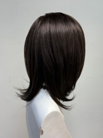 A mannequin head with long hair and black color.