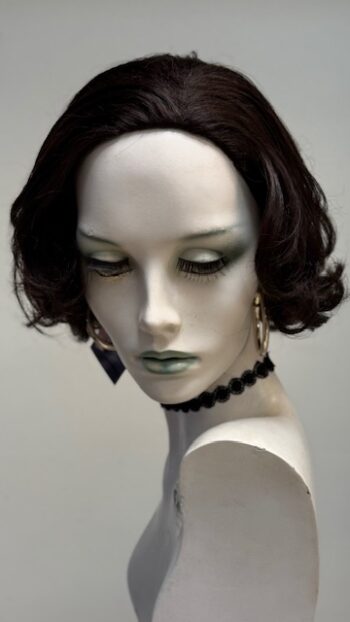 A mannequin with green eyes and black hair.