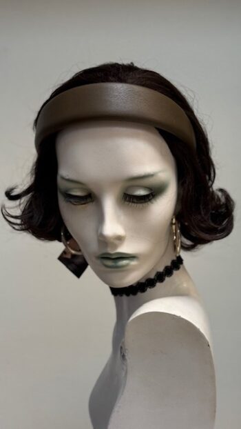 A mannequin with green eyes and black hair.