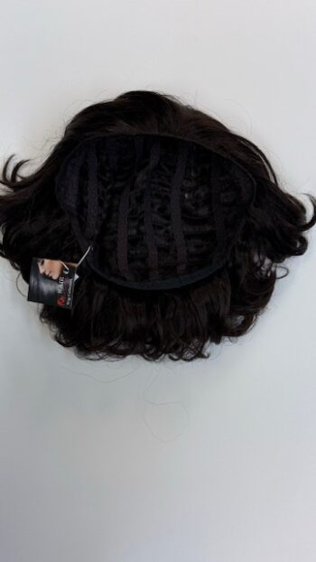 A black wig hanging on the wall