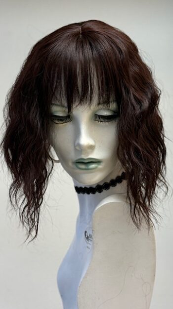 A mannequin head with a black choker and long necklace.