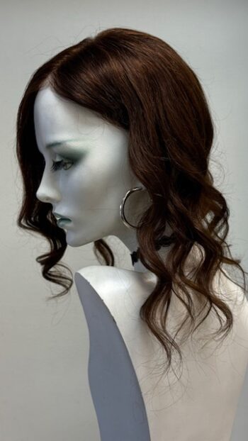 A mannequin with long dark hair and green eyes.