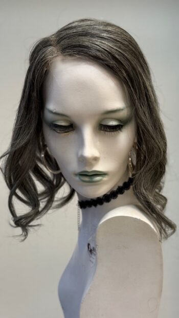 A mannequin with long hair and green eyes.