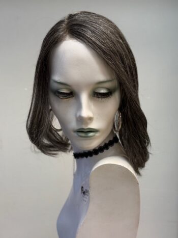 A mannequin with long hair and green eyes.