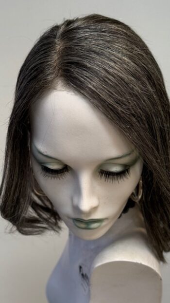 A close up of a doll head with long eyelashes