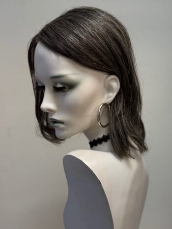 A mannequin with long hair and green eyes.