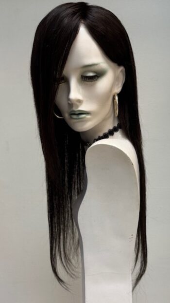 A mannequin with long black hair and green eyes.