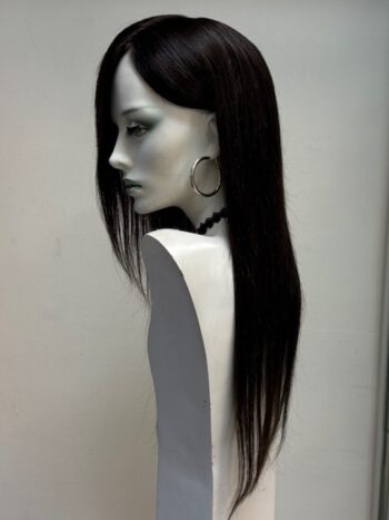 A mannequin with long black hair and earrings.