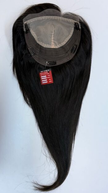 A long black hair wig hanging on the wall.