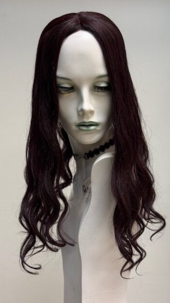 A mannequin with long dark hair and a necklace.