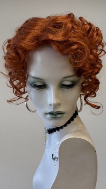 A mannequin with red hair and green eyes.