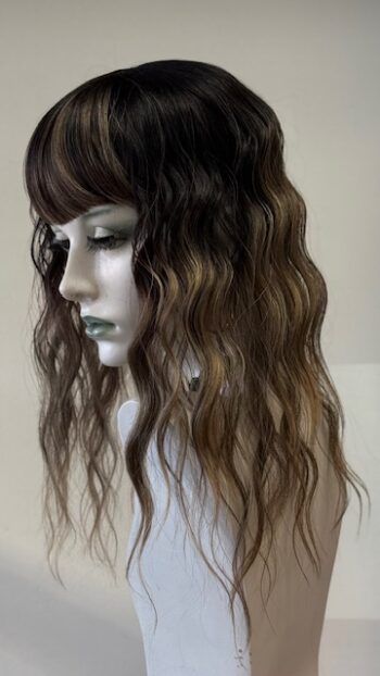 A mannequin with long hair and bangs.