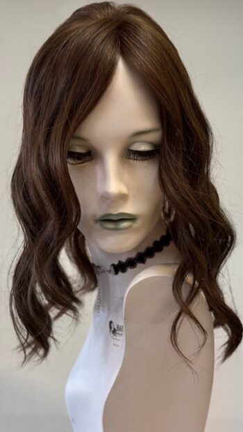 A mannequin with long brown hair and green lipstick.