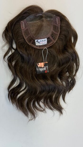 A brown wig hanging on the wall