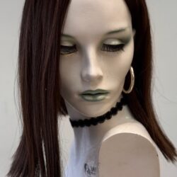 A mannequin with long hair and green lipstick.