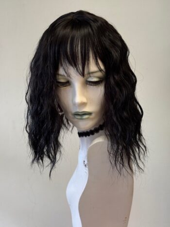 A mannequin wearing a wig and necklace.