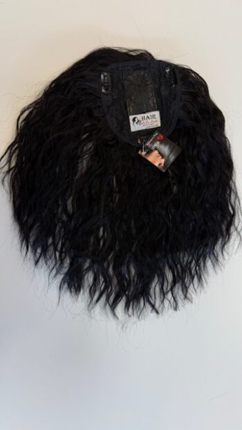 A black bag with fake hair on the front.