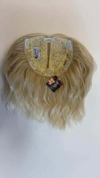 A blonde wig hanging on the wall