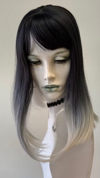 A mannequin with long black hair and green makeup.