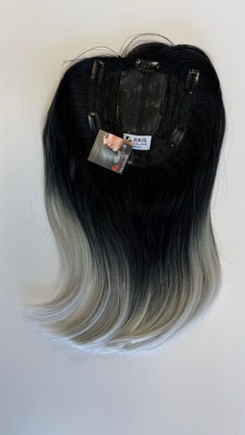 A black wig with silver highlights on top of it.