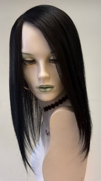 A mannequin wearing a wig and necklace.