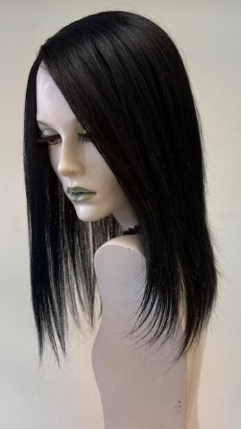 A mannequin head with long black hair on display.