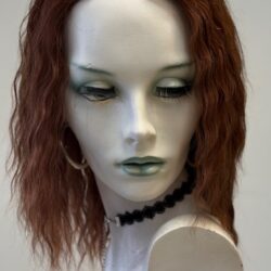 A mannequin with long red hair and green eyes.