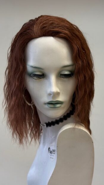 A mannequin with long red hair and green eyes.