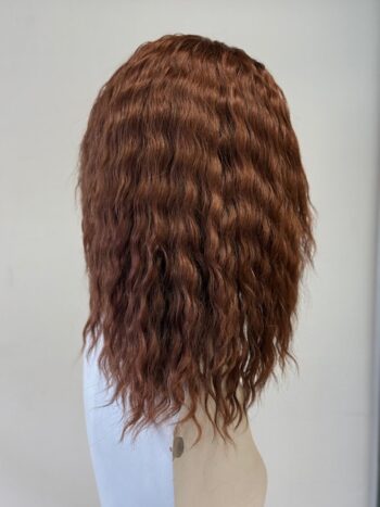 A woman with long brown hair is standing.