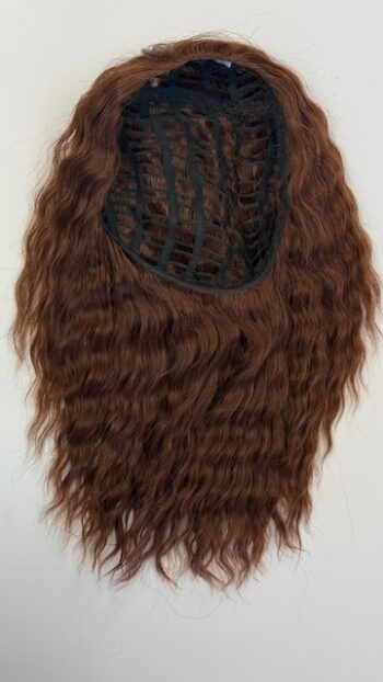 A brown wig hanging on the wall