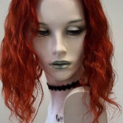 A mannequin with red hair and black necklace.