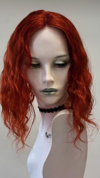 A mannequin with red hair and black necklace.