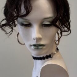 A mannequin with black hair and green eyes.