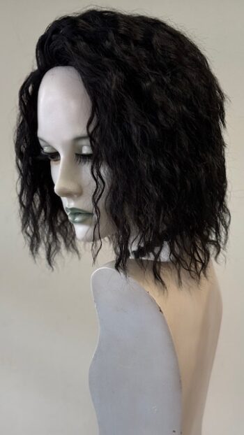 A mannequin with long black hair and green eyes.