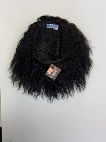 A black wig hanging on the wall