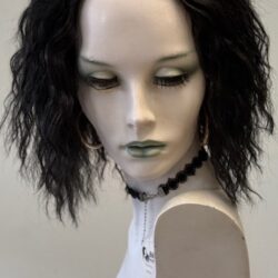 A mannequin with black hair and green eyes.