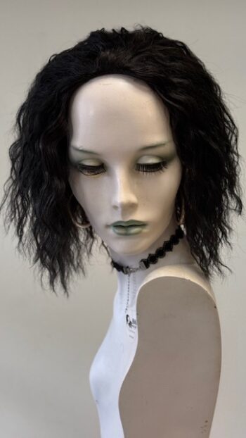 A mannequin with black hair and green eyes.