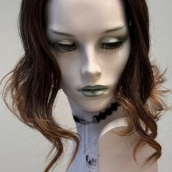 A mannequin with long hair and green eyes.